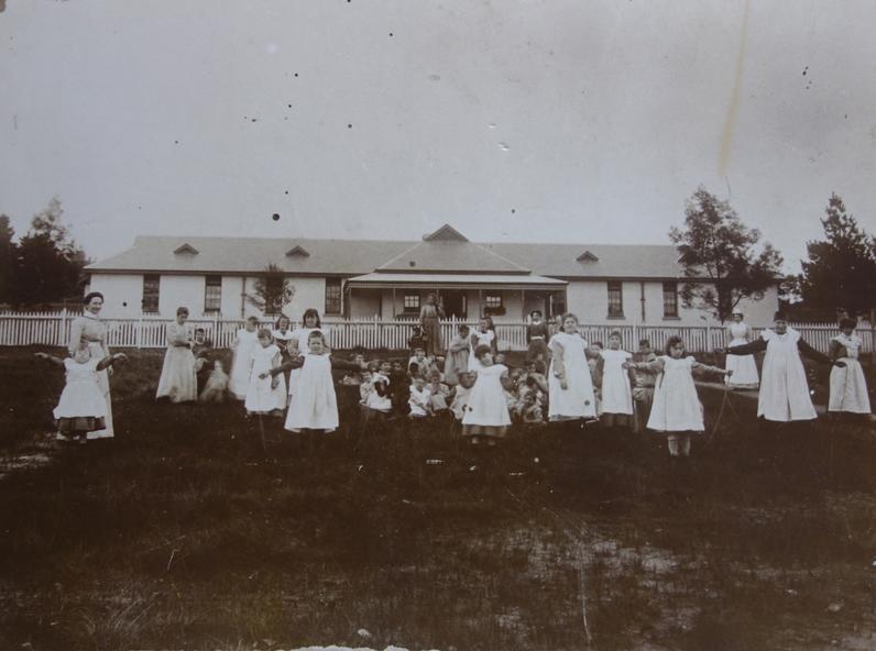 Girls in front of Ward 25, Kew Cottages. Dr. Cliff Judge [photographer]. Photo Source - Victorian Collections